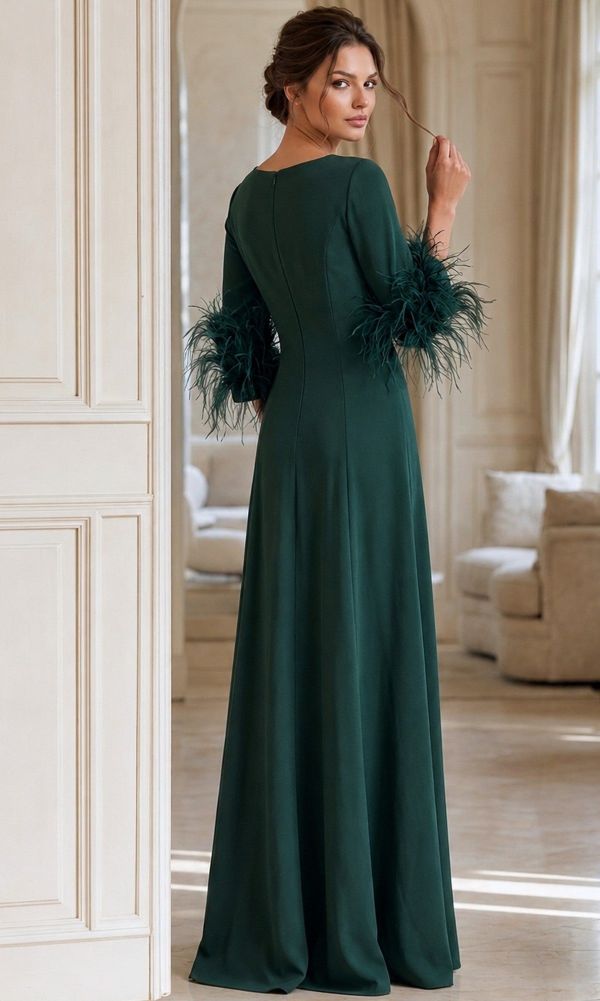A woman stands indoors in a long, dark green Jovani 40200 formal dress with feathered sleeves, facing away while looking over her shoulder.